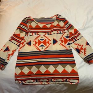 Marcelle Red, Blue, & Tan three quarter length printed shirt.